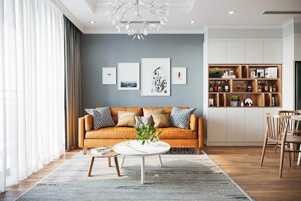 Mảng tường đối diện được đặt 1 chiếc kệ tivi bằng gỗ kiểu cách hiện đại chi tiết đơn giản nhưng tiện nghi nhất định. Chiếc kệ trang trí ngang được đặt trên cao giúp cho mảng tường không còn trống trải. Thiết kế nội thất phòng khách chung cư hiện đại, đẹp