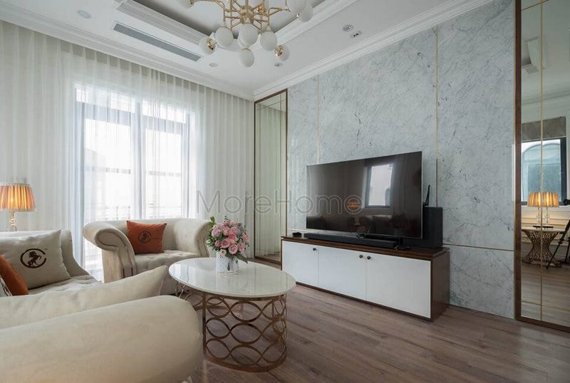 Gương dán tường khung gỗ có thể giúp mở rộng diện tích của phòng khách bằng cách chạm trần.